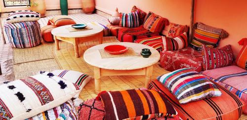 a living room with a couch and a table with pillows at Dellarosa Boutique Hotel and Spa in Marrakech
