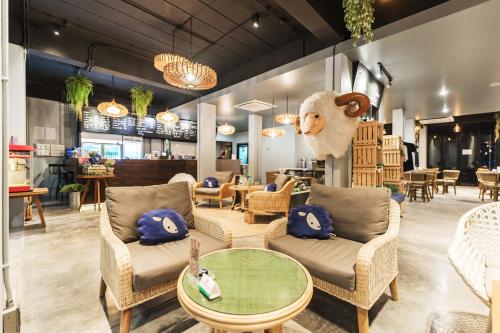 a store with chairs and a stuffed animal on the wall at Kokotel Krabi Oasis in Ao Nang Beach