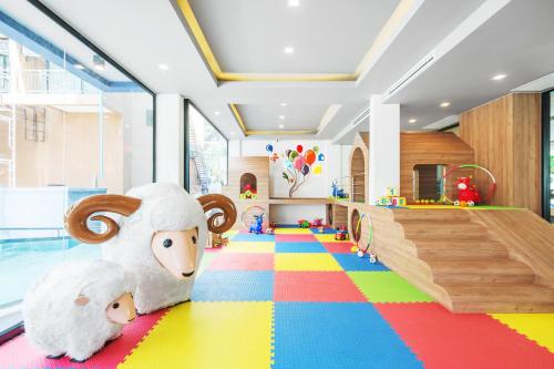 a childs play room with a stuffed animal on the floor at Kokotel Krabi Oasis in Ao Nang Beach