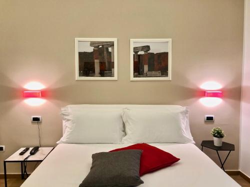 a bedroom with two lights above a white bed at Residenza Madonna in Pompei
