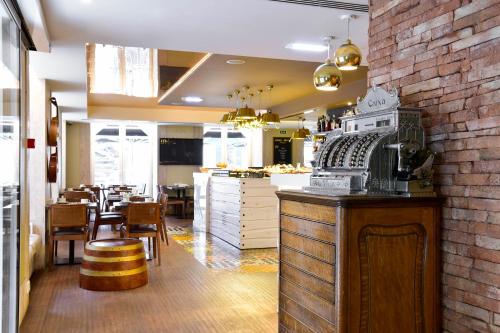 a restaurant with a kitchen and a dining room at My Story Hotel Ouro in Lisbon
