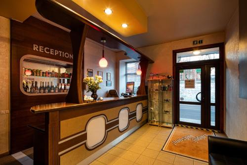 a bar in a restaurant with a counter at Biplan Hotel in Daugavpils