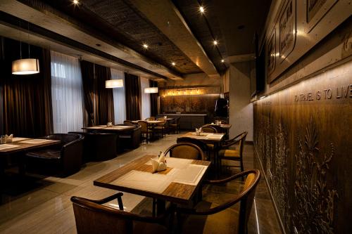 a dining room with tables and chairs in a restaurant at Biplan Hotel in Daugavpils