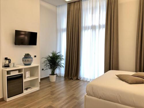 a bedroom with a bed and a television in a room at Residenza Madonna in Pompei