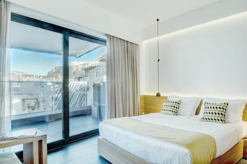 Ένα ή περισσότερα κρεβάτια σε δωμάτιο στο Athens Lodge by Athens Prime Hotels