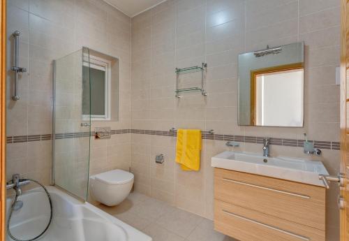 a bathroom with a sink toilet and a shower at Apartment with Pool in Sliema