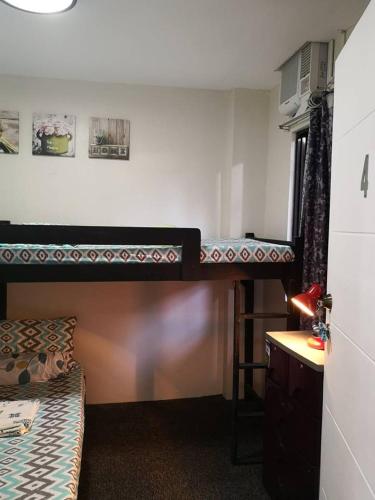 a room with two bunk beds and a desk at Anabelle Residence in Dumaguete