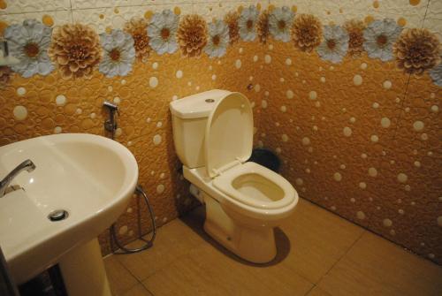 a bathroom with a toilet and a sink at Singh Brothers in Adams Peak
