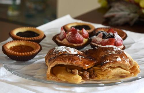 a plate of pastries with fruit on a table at Villa Campo dei Fiori in Casciago