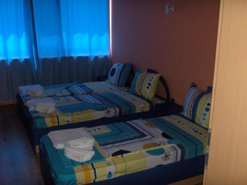 two beds sitting next to each other in a room at Dara Hotel in Primorsko