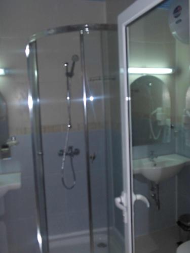 a bathroom with a shower and a sink at Dara Hotel in Primorsko