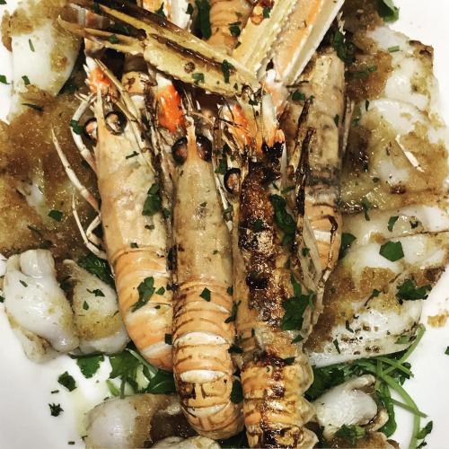 a plate of food with shrimp and other foods at Il Pozzo Country House in Collescipoli