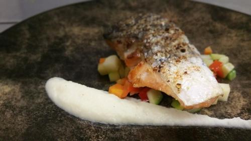 a piece of fish and vegetables on a plate at Boutique Hotel de Rozenhof in Heilig Landstichting
