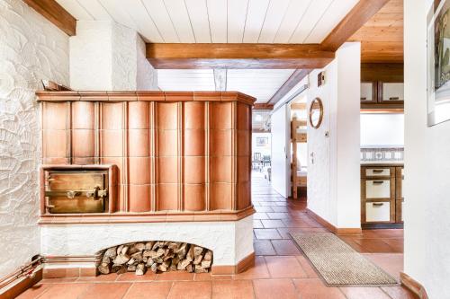 a kitchen with a woodburning stove in a house at Chalet Zentral Bach by A-Appartments in Brand