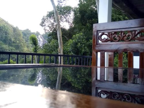 a balcony with a view of a waterfall at Ever Green Mount in Ella
