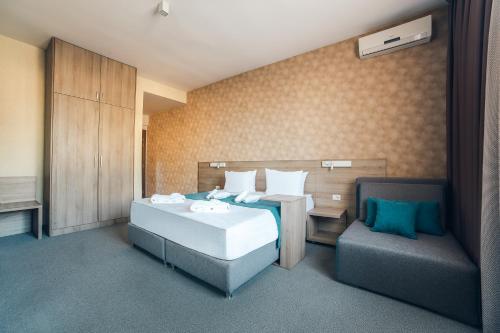 Postel nebo postele na pokoji v ubytování Garni Hotel Mint
