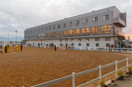 a building in front of a building with a arena at Hotel Frigopan in Plovdiv