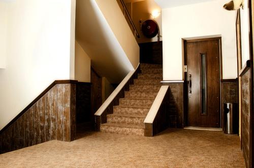 a staircase in a building with a wooden door at Marble Tower in Beirut