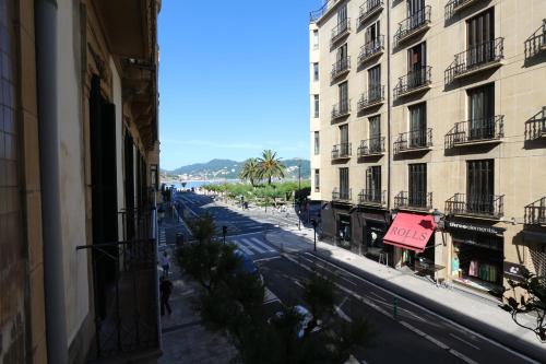 a view of a city street with buildings and a pink sign at Modern & spacious apartment near La Concha Bay in Donostia-San Sebastián