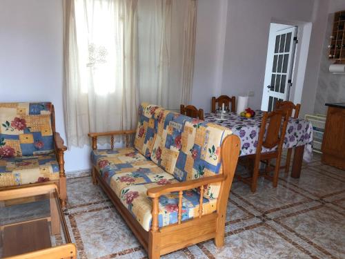 a living room with a couch and a table at ÁTICO ESTRELLA in Tejina de Isora