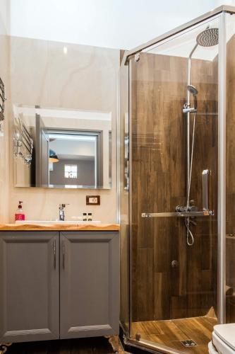a bathroom with a shower and a sink at Guest House People in Korçë