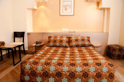 a bedroom with a bed and a table and a chair at Marble Tower in Beirut