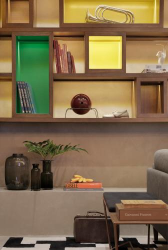 a living room with wooden shelves with books at Yoo2 Rio de Janeiro, Tapestry Collection by Hilton in Rio de Janeiro