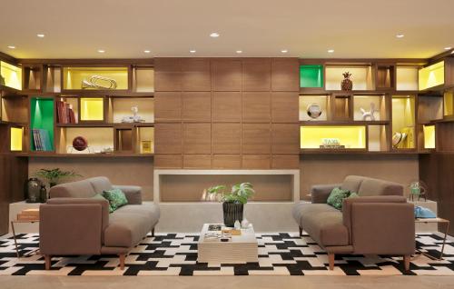 a living room with two couches and a table at Yoo2 Rio de Janeiro, Tapestry Collection by Hilton in Rio de Janeiro