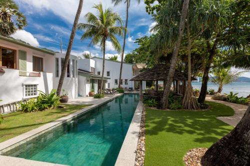 a swimming pool in the backyard of a villa at Kalim Beach House - Private Beach & Pool in Patong Beach