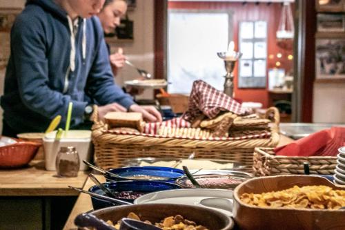 a group of people sitting at a table with food at Hotell Bruksvallsliden in Bruksvallarna