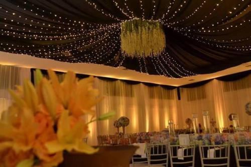 a banquet hall with chairs and a chandelier at Terra Toscana Hotel in Mangue