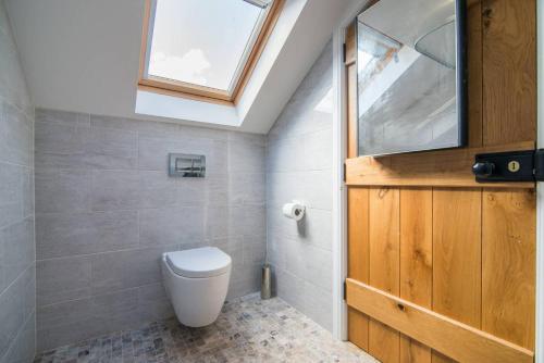 a bathroom with a toilet and a skylight at Hillside House in Chester