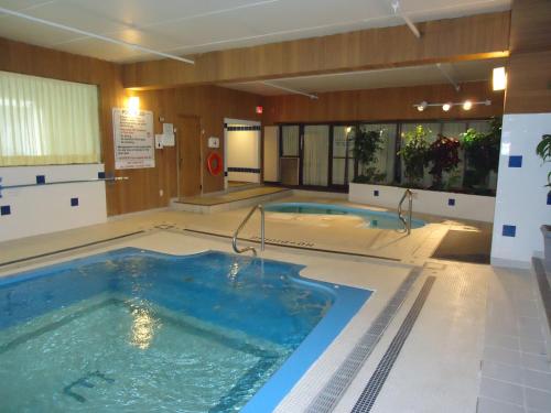 a large swimming pool in a hotel room at The Fredericton Inn in Fredericton