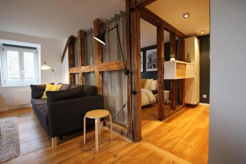 a living room with a couch and a table at Appartement Cocoon Hypercentre in Strasbourg