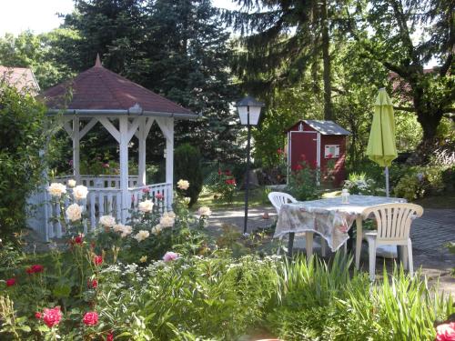 a gazebo with a table and chairs in a garden at Haus Jeremias therme in Zalakaros