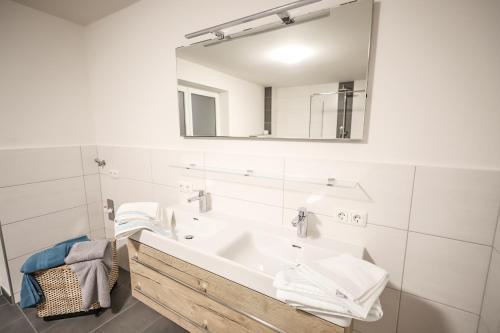 a bathroom with a sink and a mirror at Landhaus zur Tanne in Feld am See