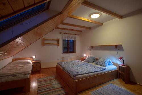 a bedroom with two beds in a attic at Na samotě u lesa in Žamberk