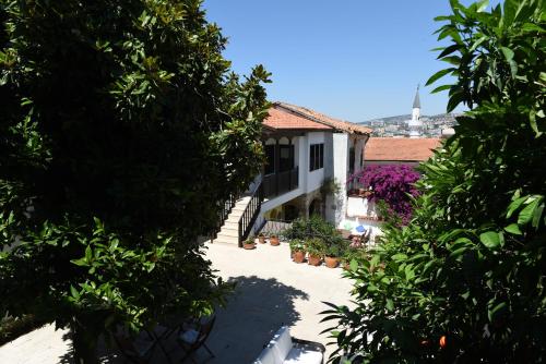 a view of a house through the trees at Villa Konak Hotel in Kusadası