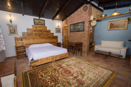 a bedroom with a bed and a chair and a rug at Agriturismo Papyrus in Siracusa