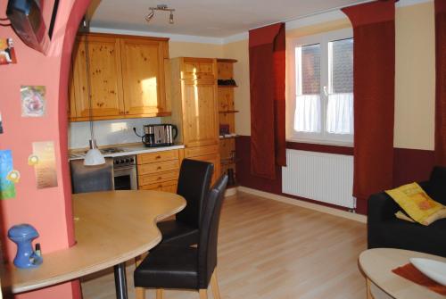 a kitchen and living room with a table and chairs at CasaCreativa in Bad Windsheim