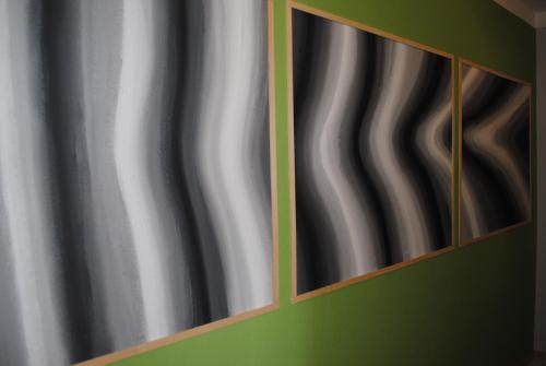 a pair of mirrors on a wall next to a curtain at CasaCreativa in Bad Windsheim