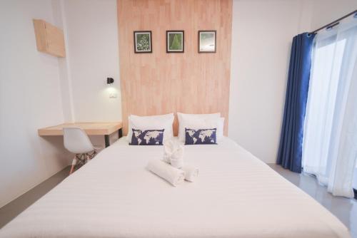 Postel nebo postele na pokoji v ubytování The Cozy Hotel