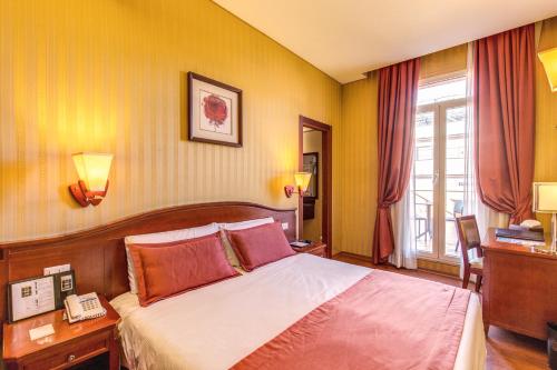 a hotel room with a bed and a window at Augusta Lucilla Palace in Rome