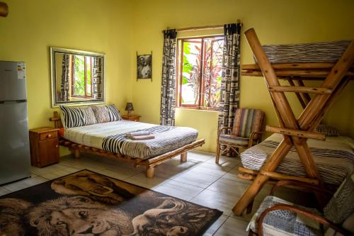 a bedroom with a bunk bed and a ladder at Ku-Boboyi River Lodge in Port Edward