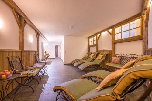 a room with a bunch of chairs and tables at Apart S'Dörfl in Mayrhofen