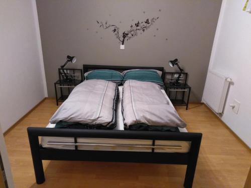 a bed with two pillows on it in a room at Ilka´s kleine Harmonie in Leipzig