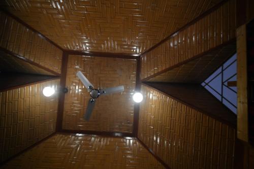 a room with a ceiling with a fan and lights at Goona palace houseboats in Srinagar