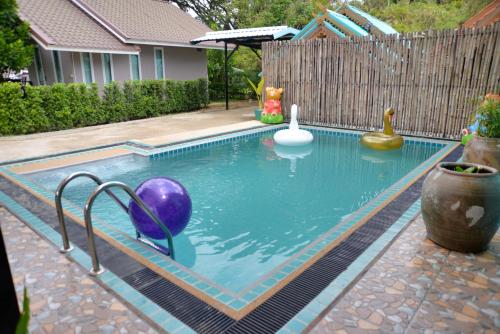 a swimming pool with a ball in the water at Chanpraya Resort in Chanthaburi