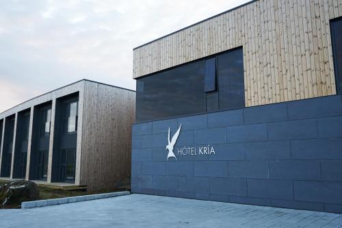 a building with a sign on the side of it at Hótel Kría in Vík