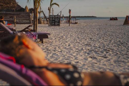 a view of a beach with a person laying in avisorvisorvisor at Mocco Beach Villa in Kendwa